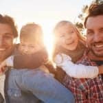 Co-parenting legal rights same-sex parents with children enjoying time together outdoors