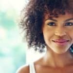 portrait smiling young black woman sunlight