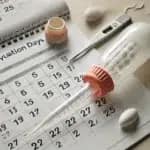Turkey Baster Method for home insemination, showing a turkey baster and a calendar used to track ovulation timing.