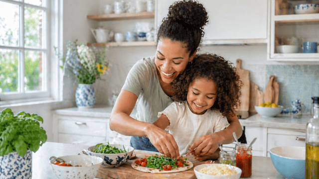 single mom cooking with her child in the kitchen and preparing a meal together