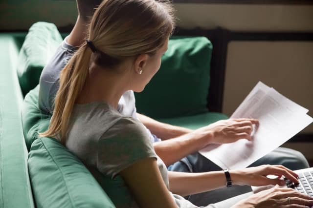 Co-parenting agreement couple reviewing documents and filling online form together