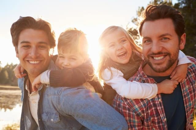 Co-parenting legal rights same-sex parents with children enjoying time together outdoors