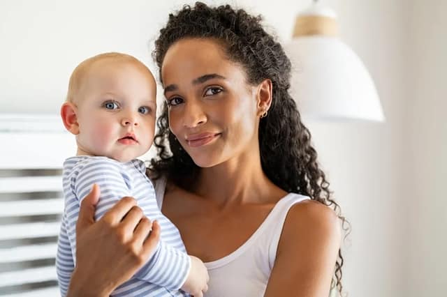 adopt a child concept with a mother holding a baby at home