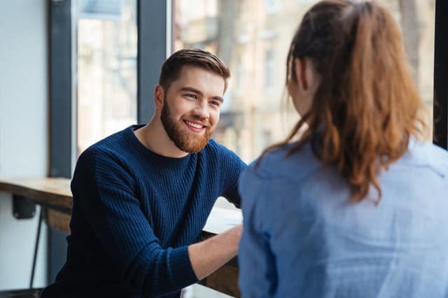 Co-parenting contract man and woman discussing agreement together in a cafe