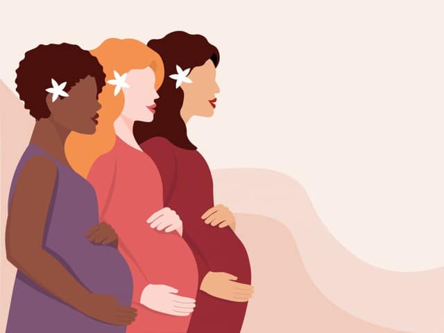 several young pregnant women stand profile