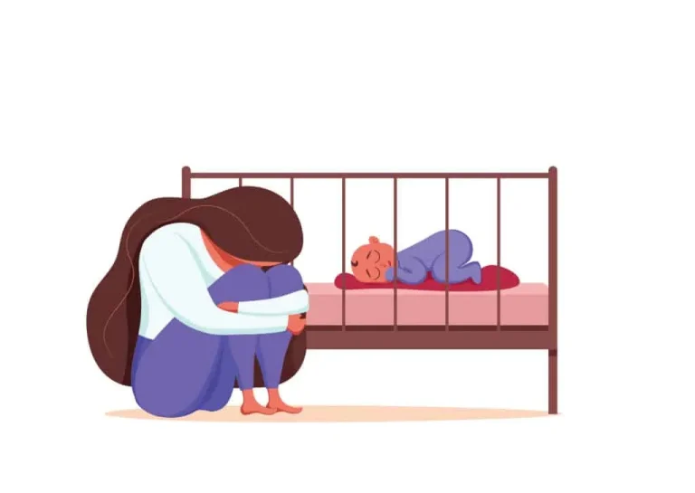 baby blues – sad and exhausted mother sitting beside a sleeping baby in a crib