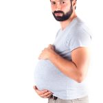 couvade syndrome man holding his belly mimicking pregnancy symptoms