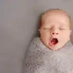 Donor conceived baby bonding newborn baby yawning in close-up during early bonding moment